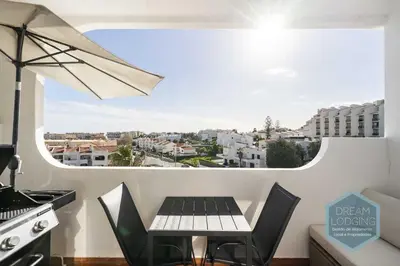 a kitchen with a table and a view of a city at Moai - Dream Lodging in Albufeira