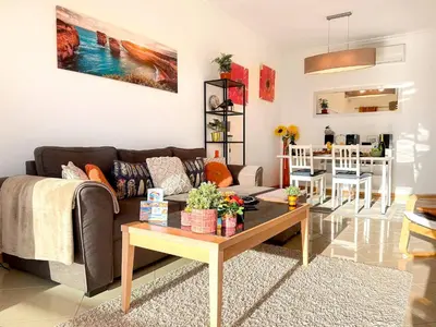 a living room with a couch and a table at AlbufeiraOrada Cozy&Sunny Condo by BeCherish in Albufeira