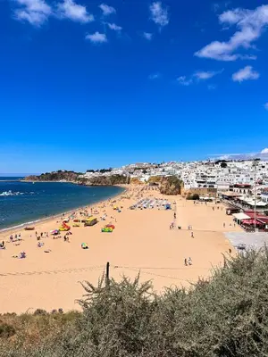 a group of people on a beach with the ocean at AlbufeiraOrada Cozy&Sunny Condo by BeCherish in Albufeira