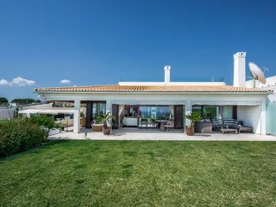 a large white house with a patio and grass at Outstanding Algarve Villa 8 Bedrooms Villa Agua Grande Deluxe Seaviews in Albufeira