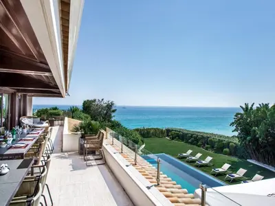 an outdoor patio with a view of the ocean at Outstanding Algarve Villa 8 Bedrooms Villa Agua Grande Deluxe Seaviews in Albufeira