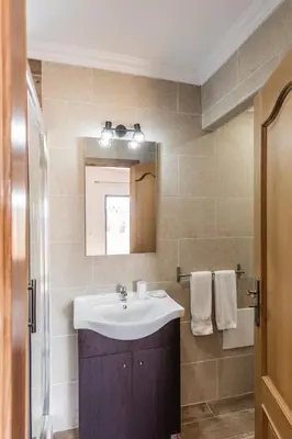 a bathroom with a sink and a mirror at Quinta Vita - Vila Limao in Almancil