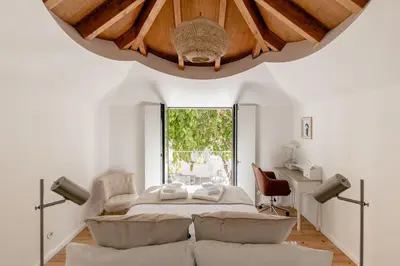 a bedroom with a bed and a large window at Casa Passion in Faro