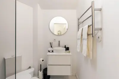 a white bathroom with a sink and a mirror at Casa Passion in Faro