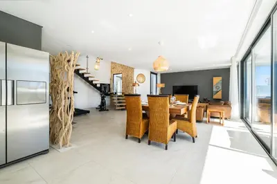 a kitchen and dining room with a table and chairs at Villa Kambole in Albufeira