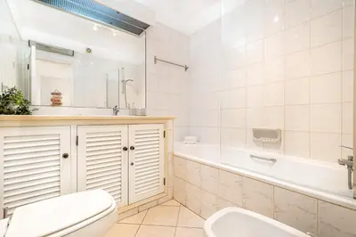 a bathroom with a toilet and a tub and a sink at BeGuest Balaia Apartment 137 in Albufeira