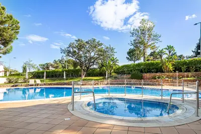 a swimming pool at a resort with trees at BeGuest Balaia Apartment 137 in Albufeira