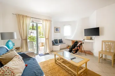 a living room with a blue couch and a table at BeGuest Balaia Apartment 137 in Albufeira