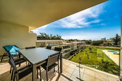 a table and chairs on a balcony with a view at Monte Balaia AT19 Duplex - Pool View Olhos de Agua in Olhos de Água