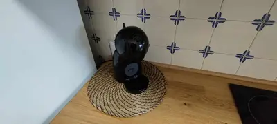 a black hair dryer sitting on the floor in a bathroom at Albufeira INN - Lote 6 T1 in Albufeira