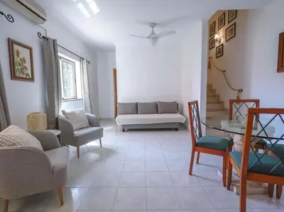 a living room with a couch and a table and chairs at Oura Sunrise 16 Apartment by Stay ici Algarve Holiday Rental in Albufeira