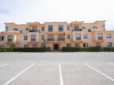 a large building with a parking lot in front of it at Oura Sunrise 16 Apartment by Stay ici Algarve Holiday Rental in Albufeira