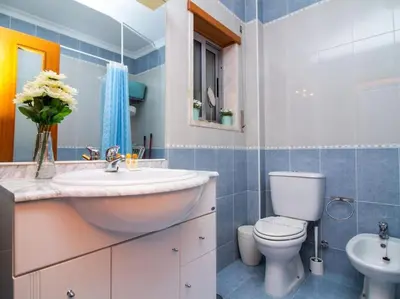 a bathroom with a sink and a toilet at Globe 33 Apartment by Stay ici Algarve Holiday Rental in Albufeira