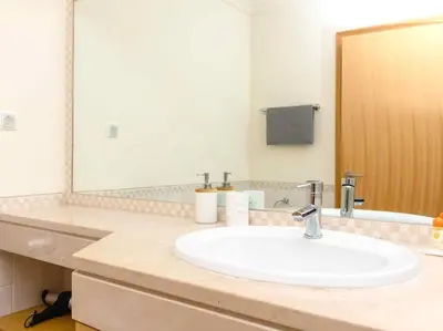 a bathroom with a sink and a large mirror at View Waves Apartment by Stay ici Algarve Holiday Rental in Albufeira