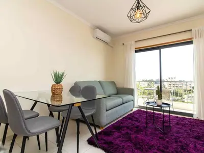 a living room with a table and a couch at View Waves Apartment by Stay ici Algarve Holiday Rental in Albufeira