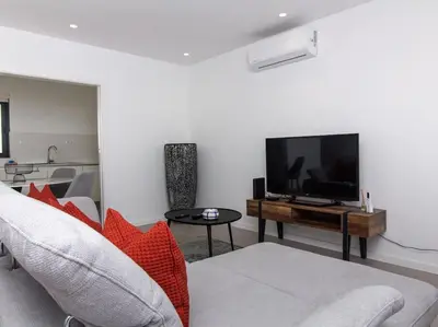 a living room with a couch and a flat screen tv at Panoramic E Apartment by Stay ici Algarve Holiday Rental in Albufeira