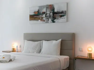 a bedroom with a large white bed with two lamps at Panoramic E Apartment by Stay ici Algarve Holiday Rental in Albufeira