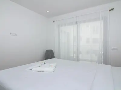 a white bed with a towel on it in a room at Panoramic E Apartment by Stay ici Algarve Holiday Rental in Albufeira