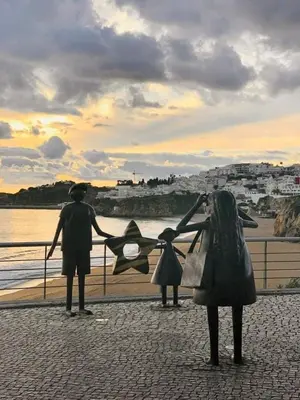 a man and a woman standing next to a body of water at Sun & Nature Apartment Corcovada in Albufeira