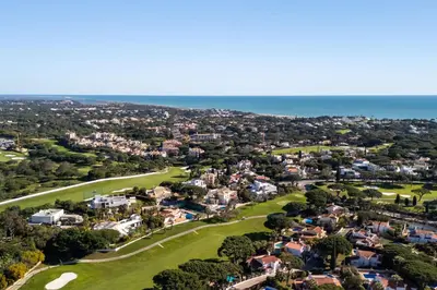 an aerial view of a golf course with the ocean at Cozy 2 BDR W/Balcony in Vale do Lobo by LovelyStay in Vale do Lobo