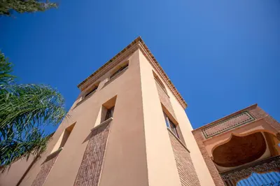 a tall building with a blue sky in the background at Al Karob Yoga Boutique Hotel in Guia