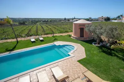 a swimming pool in a yard with a gazebo at Al Karob Yoga Boutique Hotel in Guia