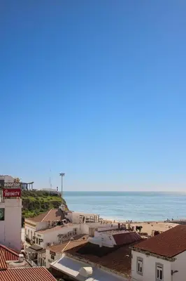 a view of the beach from the roofs of buildings at Casa Brito in Albufeira