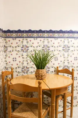 a dining room table with a potted plant on it at Casa Brito in Albufeira