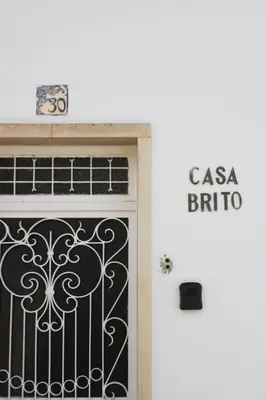 a door in front of a building with a sign at Casa Brito in Albufeira