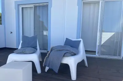 a white bedroom with a bed and a window at Villa Amêndoa in Loulé