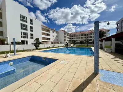 a swimming pool in front of a building at Vilamoura Marina Charming With Pool by Homing in Vilamoura