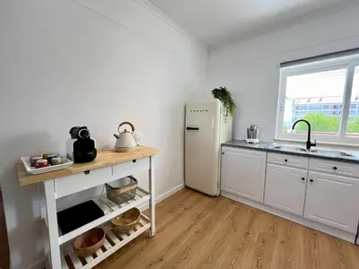 a kitchen with a white refrigerator and a sink at Vilamoura Marina Charming With Pool by Homing in Vilamoura