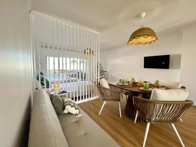 a living room with a couch and a table at Vilamoura Marina Charming With Pool by Homing in Vilamoura