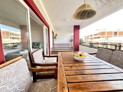 a wooden table with a bowl of fruit on a balcony at Vilamoura Marina Charming With Pool by Homing in Vilamoura