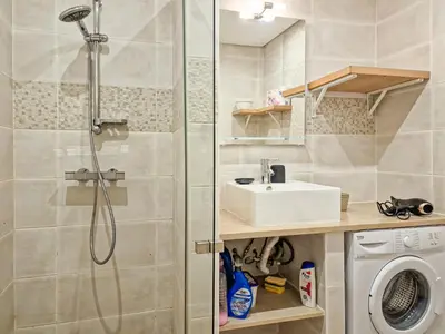 a bathroom with a shower and a sink and a washing machine at APART ALDEIA DAS AÇOTEIAS - T0 - By BEDZY in Albufeira