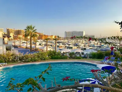 a large swimming pool in a marina with boats at Marina Garden by Ethnic Ocean in Vilamoura