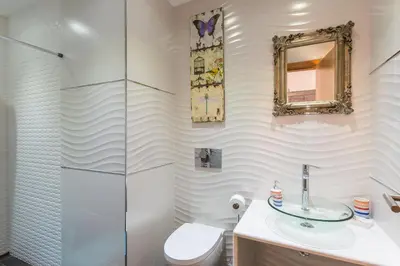 a bathroom with a toilet and a sink and a mirror at VILA RUINAS GAMITO in Guia