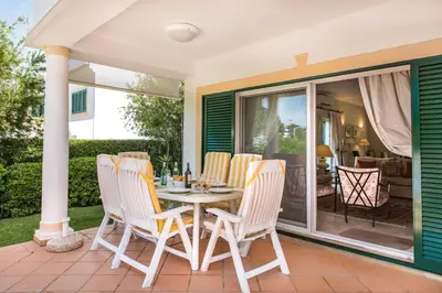 a porch with a table and chairs on it at Mng Elliott52 in Vale do Lobo