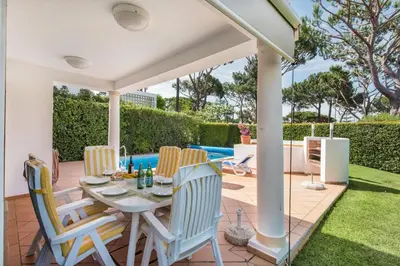 a patio with a table and chairs on a deck at Mng Elliott52 in Vale do Lobo