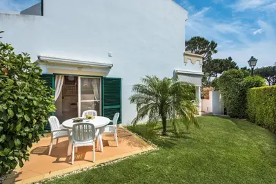 a white table and chairs on a patio at Mng Elliott50 in Vale do Lobo