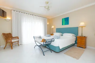 a bedroom with a bed and a table and chairs at Mng Elliott50 in Vale do Lobo