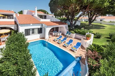 an aerial view of a house with a swimming pool at Mng Elliott25 in Vale do Lobo