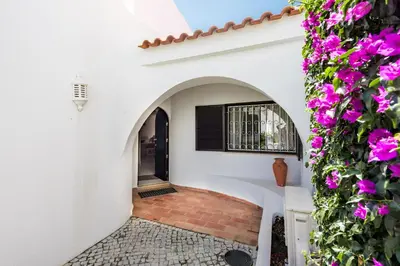a courtyard of a house with purple flowers at Mng Elliott25 in Vale do Lobo