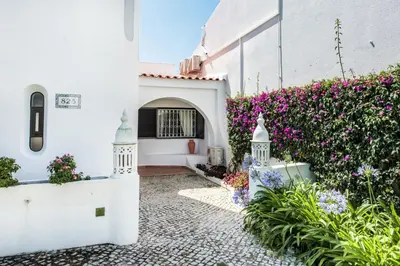 a courtyard with flowers in front of a building at Mng Elliott25 in Vale do Lobo