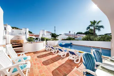 a balcony with white chairs and a table and a piano at Mng Elliott24 in Vale do Lobo