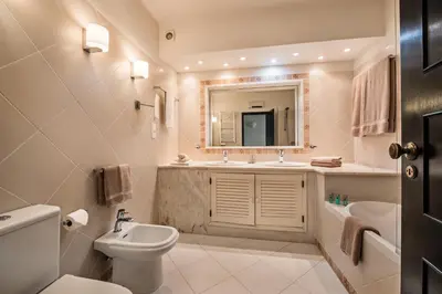 a bathroom with a sink and a toilet and a mirror at Mng Elliott13 in Vale do Lobo