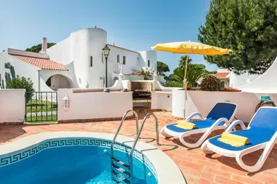 a stone retaining wall with a water fountain on a patio at Mng Elliott13 in Vale do Lobo