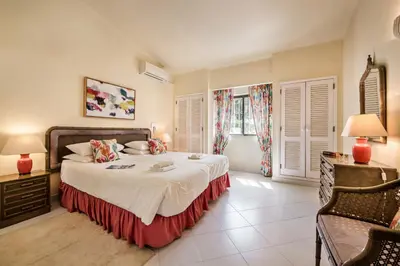 a bedroom with a large bed and two windows at Mng Elliott13 in Vale do Lobo