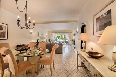 a dining room and living room with a dining table at Mng Elliott76 in Vale do Lobo