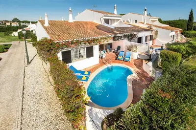 an aerial view of a house with a swimming pool at Mng Elliott74 in Vale do Lobo